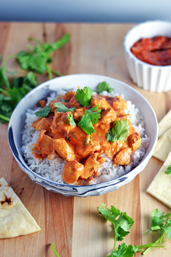 Plated Indian Butter Chicken garnished with Cilantro.