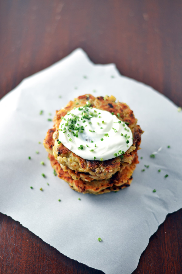 Plated Mashed Potato Bacon Pancakes with sour cream and chives.