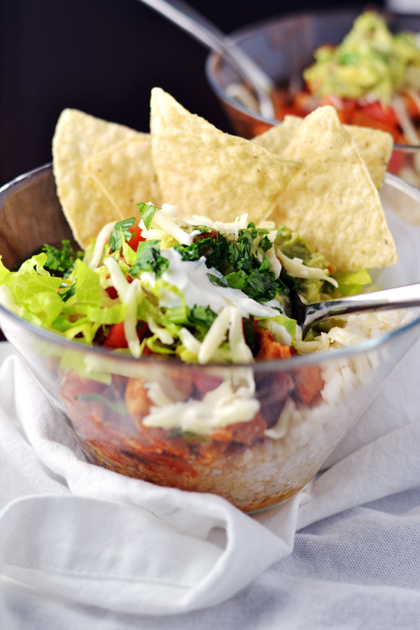 Enticing Chicken Burrito Bowls with all the toppings and chips.